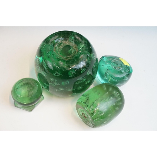 35 - Three hand blown green glass dump paperweights in varying sizes