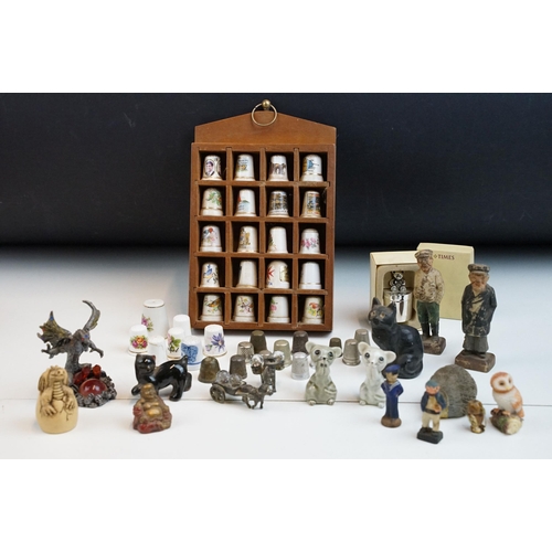 39 - Souvenir ceramic thimbles together with metal examples and wall display shelf along with an assortme... 