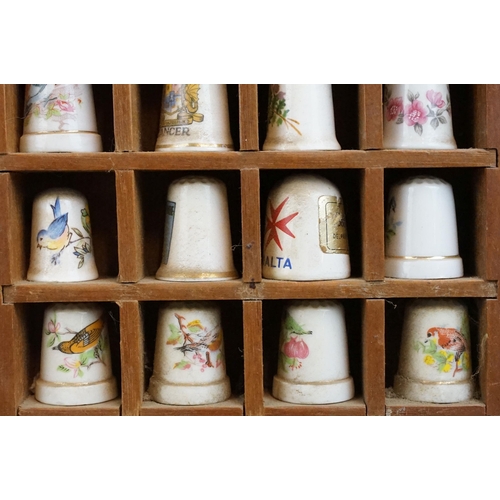 39 - Souvenir ceramic thimbles together with metal examples and wall display shelf along with an assortme... 