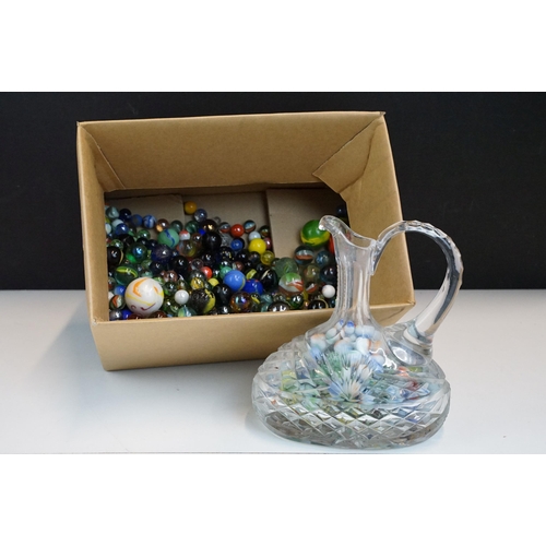 49 - Box of mixed marbles in varying sizes together with a cut glass carafe filled with marbles