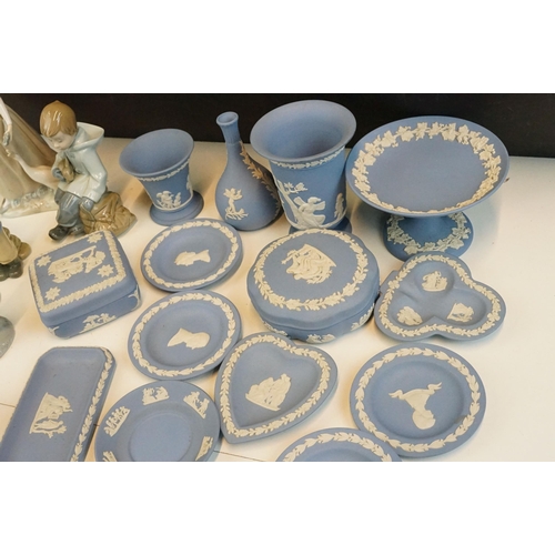 69 - Selection of Wedgwood blue Jasperware to include lidded boxes, plates and vases together with four C... 