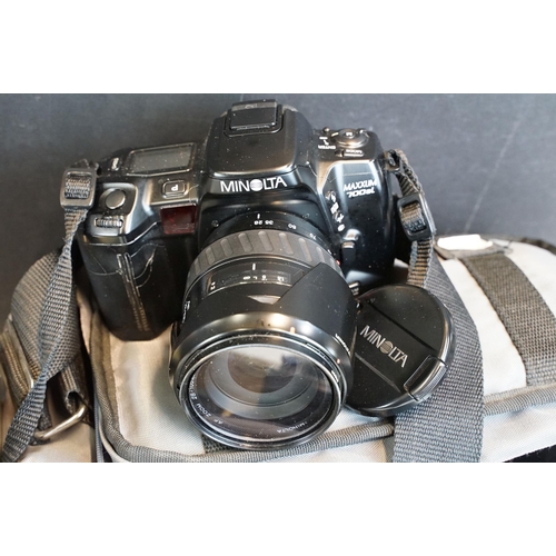 322 - Eleven 35mm SLR cameras and fourteen lenses Featuring a Nikon F fitted with a 105mm f/2.5, Canon AE1... 