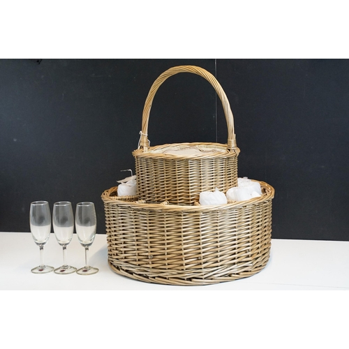 326 - Two tier handled round picnic basket with 12 champagne glasses and centre zipped insulated chiller c... 