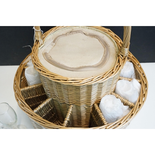 326 - Two tier handled round picnic basket with 12 champagne glasses and centre zipped insulated chiller c... 