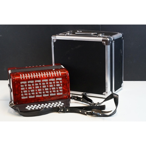 328 - Three row melodeon in red pearloid with strap, in case