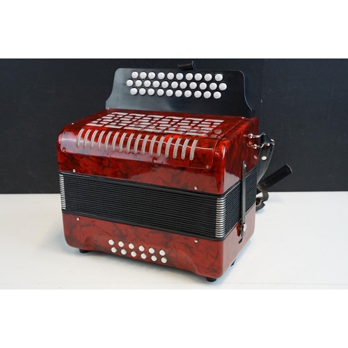 328 - Three row melodeon in red pearloid with strap, in case