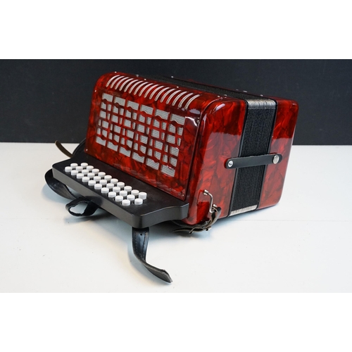 328 - Three row melodeon in red pearloid with strap, in case