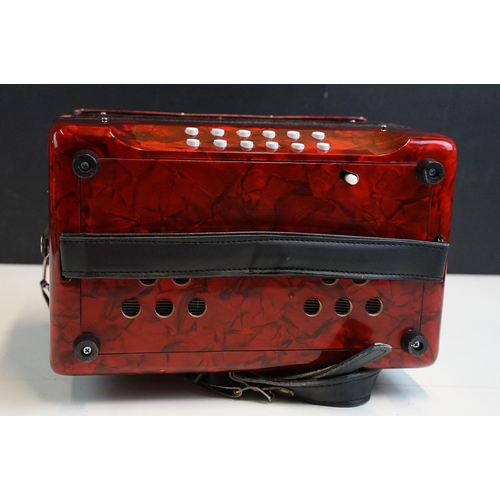 328 - Three row melodeon in red pearloid with strap, in case