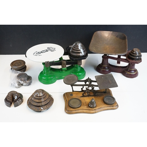 343 - Three sets of vintage weighing scales with weights to include a cast iron set of butchers scales wit... 