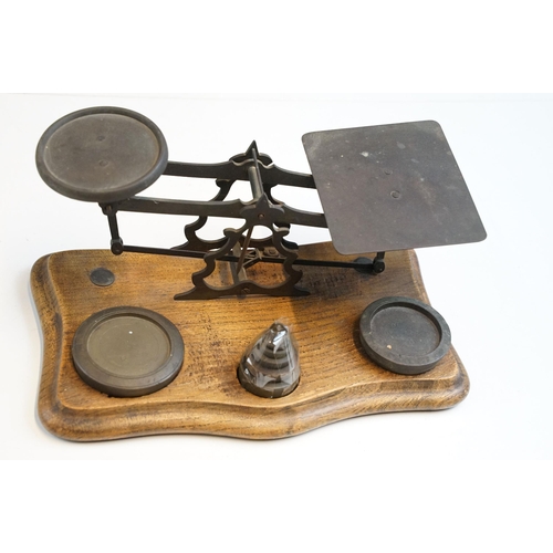 343 - Three sets of vintage weighing scales with weights to include a cast iron set of butchers scales wit... 