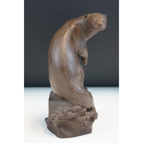 1 - Meissen Bottger Steinzeug red stoneware otter modelled perched on a rock. Impressed marks to base wi... 