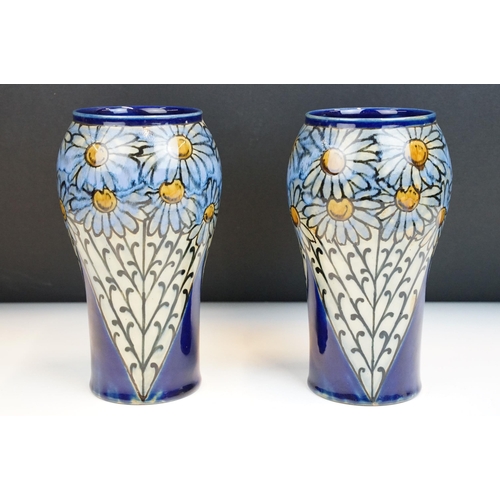 3 - Pair of early 20th Century Royal Doulton stoneware vases with hand painted daisies on a blue ground.... 