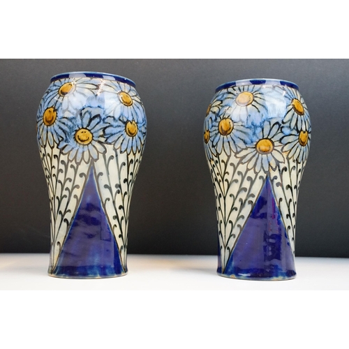 3 - Pair of early 20th Century Royal Doulton stoneware vases with hand painted daisies on a blue ground.... 