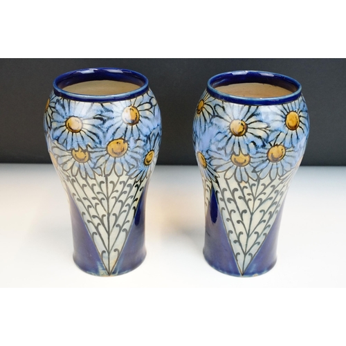 3 - Pair of early 20th Century Royal Doulton stoneware vases with hand painted daisies on a blue ground.... 