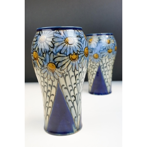 3 - Pair of early 20th Century Royal Doulton stoneware vases with hand painted daisies on a blue ground.... 