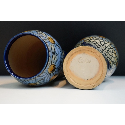 3 - Pair of early 20th Century Royal Doulton stoneware vases with hand painted daisies on a blue ground.... 