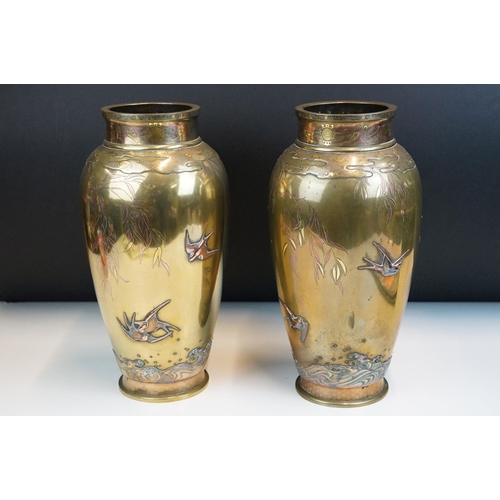 8 - Pair of Japanese Meiji mixed metal vases each decorated with moulded swallows, waves and branches wi... 