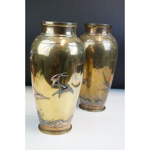 8 - Pair of Japanese Meiji mixed metal vases each decorated with moulded swallows, waves and branches wi... 