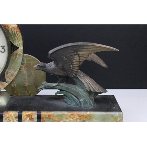 107 - 1930s Art Deco onyx and cast metal mantle clock. The clock having a round clock face with birds to e... 