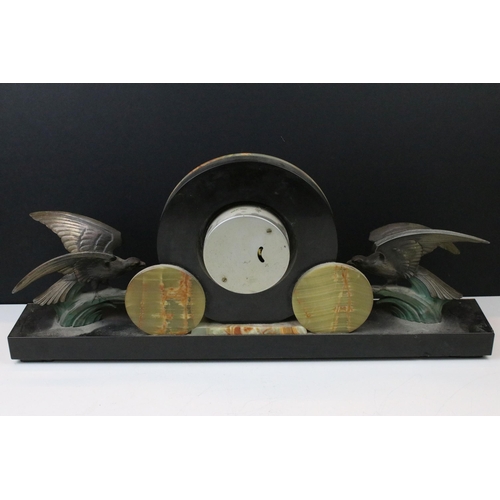 107 - 1930s Art Deco onyx and cast metal mantle clock. The clock having a round clock face with birds to e... 