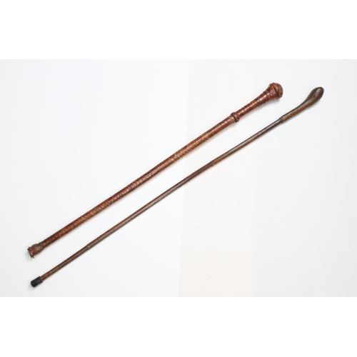 115 - Two antique leather bound riding crops, H 84cm