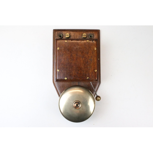 124 - Early 20th century servant’s type bell with oak case, stamped to back G.P.O M 44B 11,  28cm high