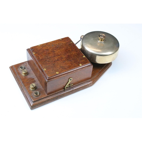 124 - Early 20th century servant’s type bell with oak case, stamped to back G.P.O M 44B 11,  28cm high