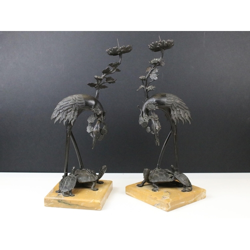 126 - Pair of Japanese Meji cast bronze candlesticks in the form of cranes upon turtles with floral sconce... 