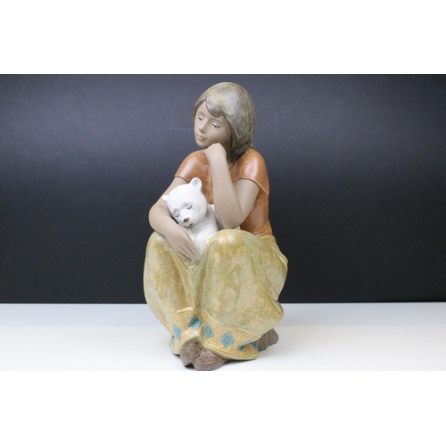 18 - Lladro A comforting friend figurine, No 2380, modelled as a young seated girl with animal, H 32cm