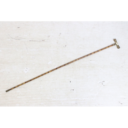 180 - Group of four bamboo walking stick canes to include one metal spiked example and a brass ended reach... 