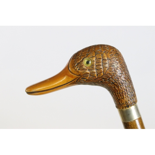 183 - Walking stick, the handle in the form of coiled snake, with yellow glass eye, the hardwood cane with... 