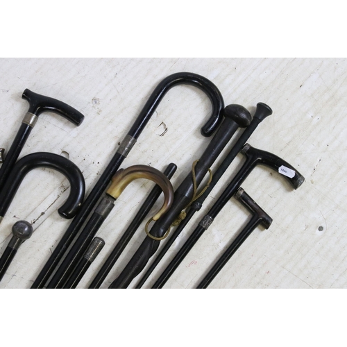 189 - Assorted ebonised wood walking stick canes with silver and horn handle examples and a riding crop