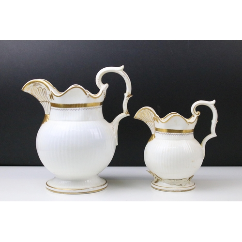 34 - Two 19th century Bloor Derby graduated jugs with gilt detail together with a Crown Derby twin handle... 