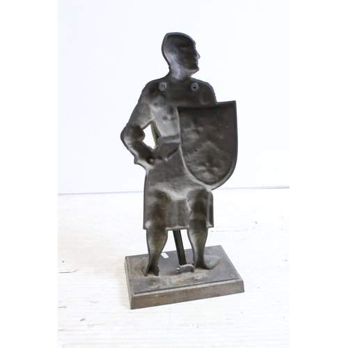 373A - Cast metal fire companion modelled as a knight in armour with poker sword, raised upon stepped recta... 