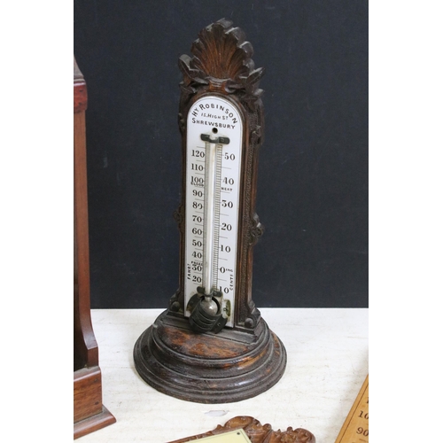 383 - Four antique wooden thermometers, free standing and wall hanging, to include makers Hy Robinson, Arc... 