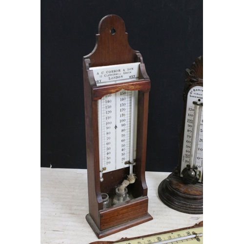 383 - Four antique wooden thermometers, free standing and wall hanging, to include makers Hy Robinson, Arc... 