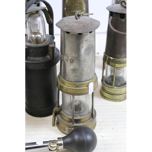 390 - Quantity of miners safety lamp lanterns to include makers Eccles 'The Protector', Ackroyd & Best tog... 