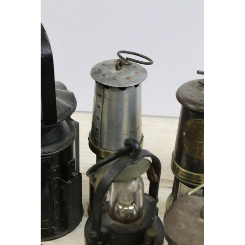 390 - Quantity of miners safety lamp lanterns to include makers Eccles 'The Protector', Ackroyd & Best tog... 