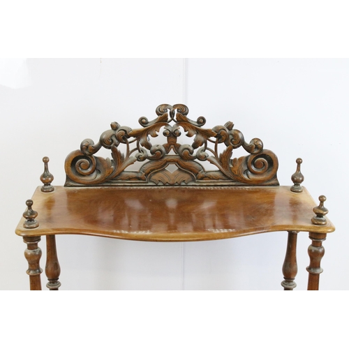 635 - Late 19th / early 20th century mahogany three tier whatnot, with intricately carved pediment, above ... 