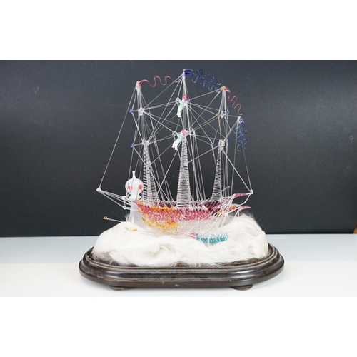 146 - 19th Century Victorian glass frigger sailing ship diorama having a glass blown ship upon a bed of wa... 