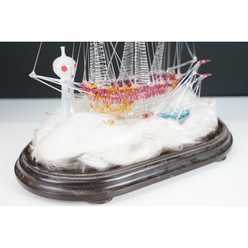 146 - 19th Century Victorian glass frigger sailing ship diorama having a glass blown ship upon a bed of wa... 