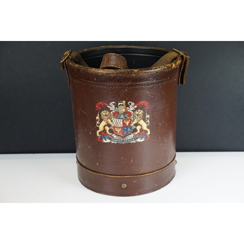 151 - Reproduction cordite bucket coal scuttle having a leather case with printed coat of arms to the fron... 