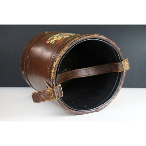 151 - Reproduction cordite bucket coal scuttle having a leather case with printed coat of arms to the fron... 