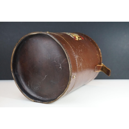 151 - Reproduction cordite bucket coal scuttle having a leather case with printed coat of arms to the fron... 