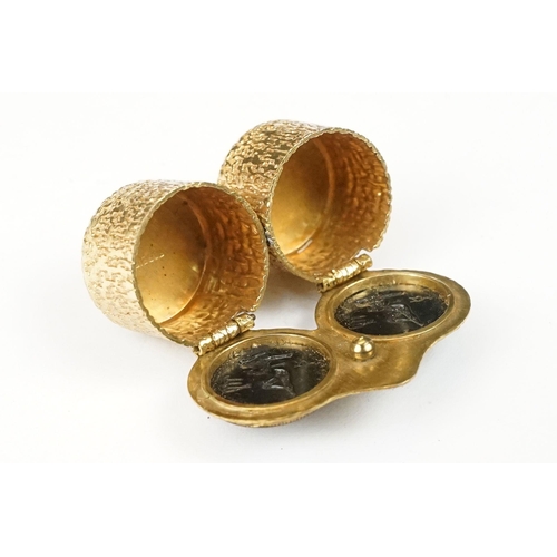 194 - Mid century gilt metal double pill or cufflink box, each lid decorated with an erotic lady and zodia... 