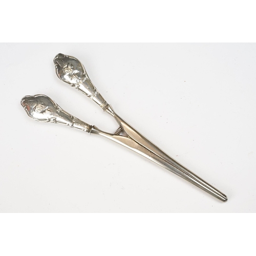 196 - Edwardian silver glove stretchers, the hallmarked handles with embossed decoration of a man’s head b... 