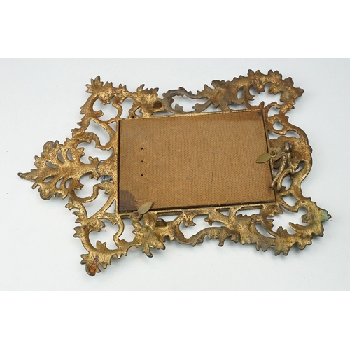 214 - Two early to mid 20th century gilt metal table mirrors with ornate floral decoration.