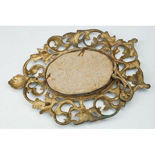 214 - Two early to mid 20th century gilt metal table mirrors with ornate floral decoration.