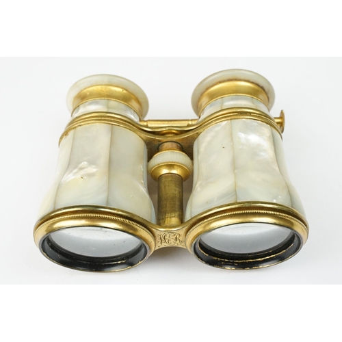 216 - A pair of gilt metal and mother of pearl multi purpose binoculars by Chevalier of Paris, three setti... 