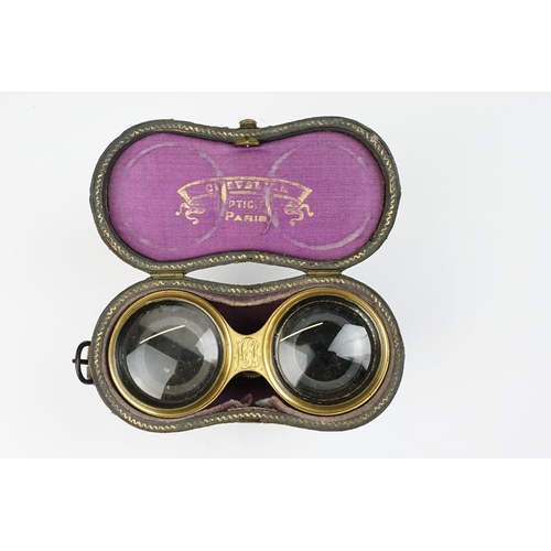 216 - A pair of gilt metal and mother of pearl multi purpose binoculars by Chevalier of Paris, three setti... 